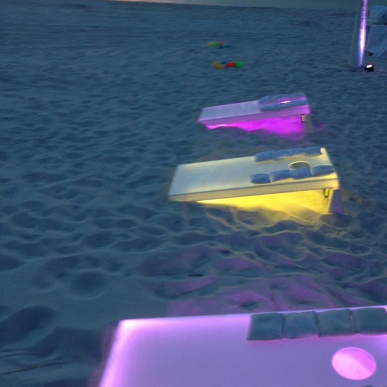 Beach cornhole boards at night glowing LED Corn Hole Light Up Yard Game Toss