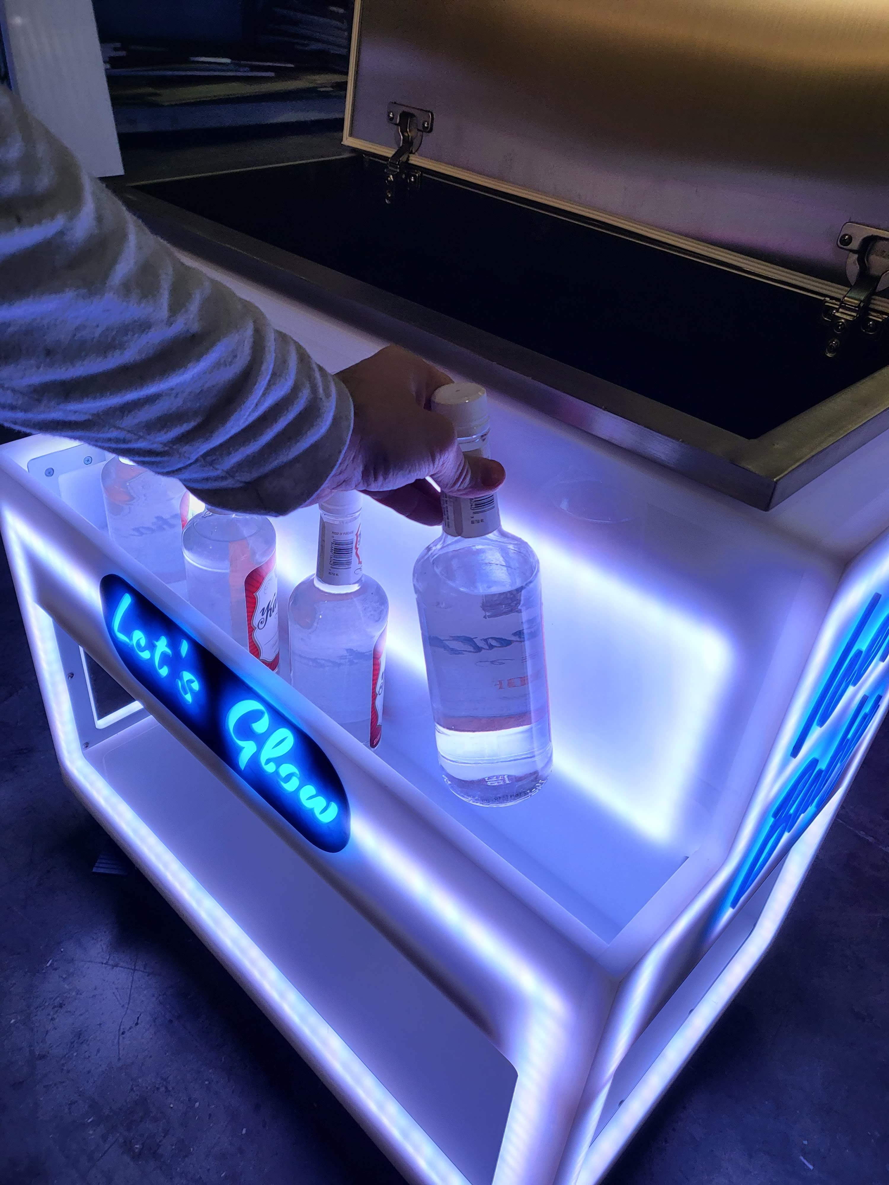 Grabbing a bottle from bar well on the LED ice chest