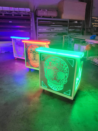 Front view of green, red, and blue lighted bars with sugarskulls